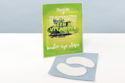 SpaLife green tea vitamin under eye strips packaging on a light blue background
