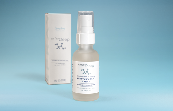 Surface Deep anti-odorant spray bottle and packaging on a blue background