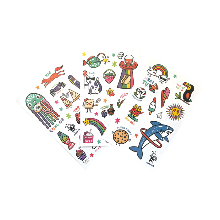 Three sheets from the OOLY Tattoo-Palooza Glow in the Dark Temporary Tattoos - Bright & Funny fanned out