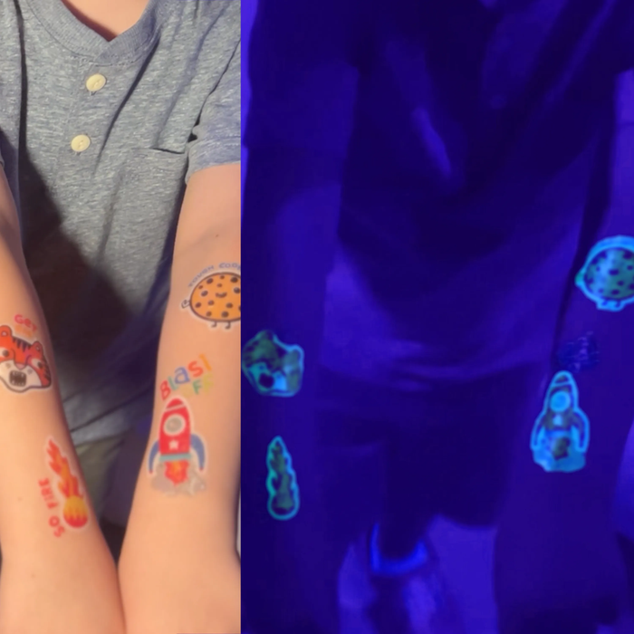 Side by side of kid with in light and dark with OOLY Tattoo-Palooza Glow in the Dark Temporary Tattoos