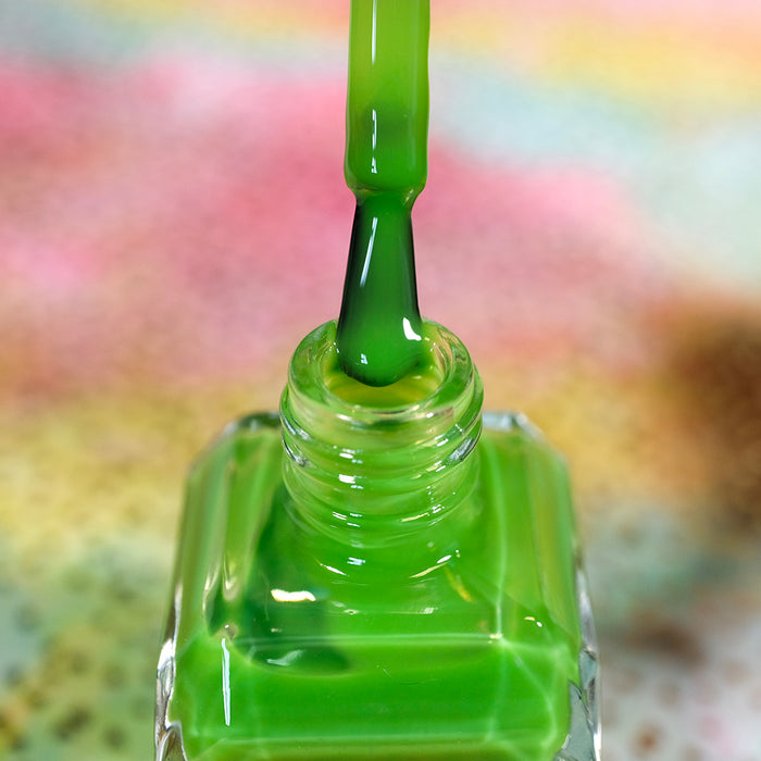 Close-up of opened nail polish bottle containing Thrilled Nail Lacquer, with brush showing.