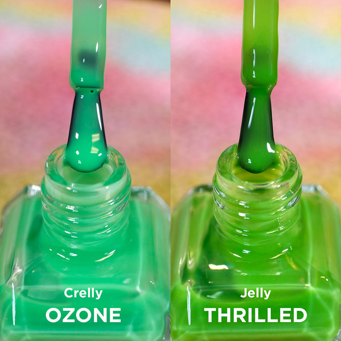 Two open bottles of nail polish with brushes showing. Comparing greens of Ozone and Thrilled Nail Lacquers.