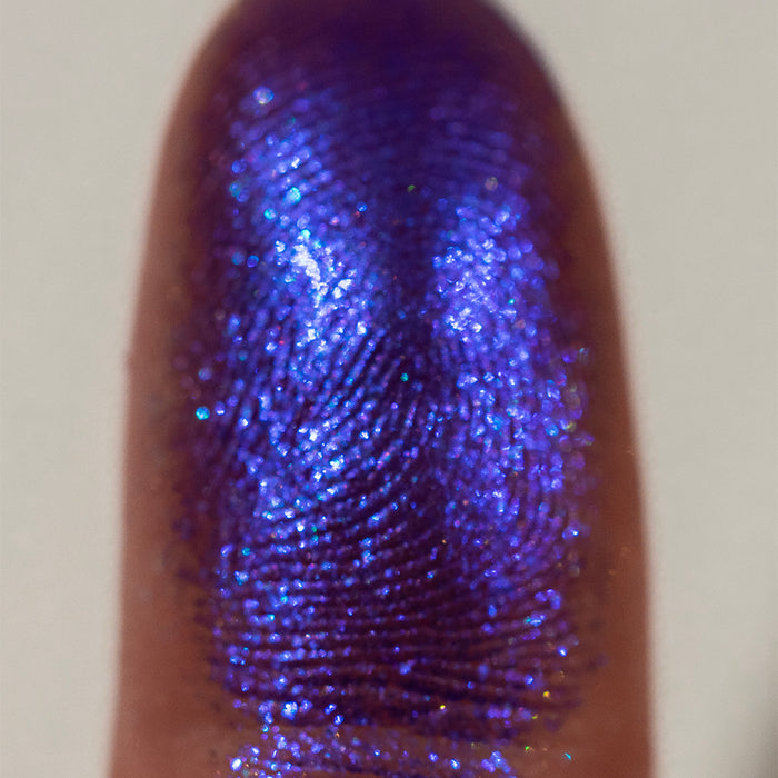 Close-up finger swatch of Tiara Eyeshadow on deep skin tone.