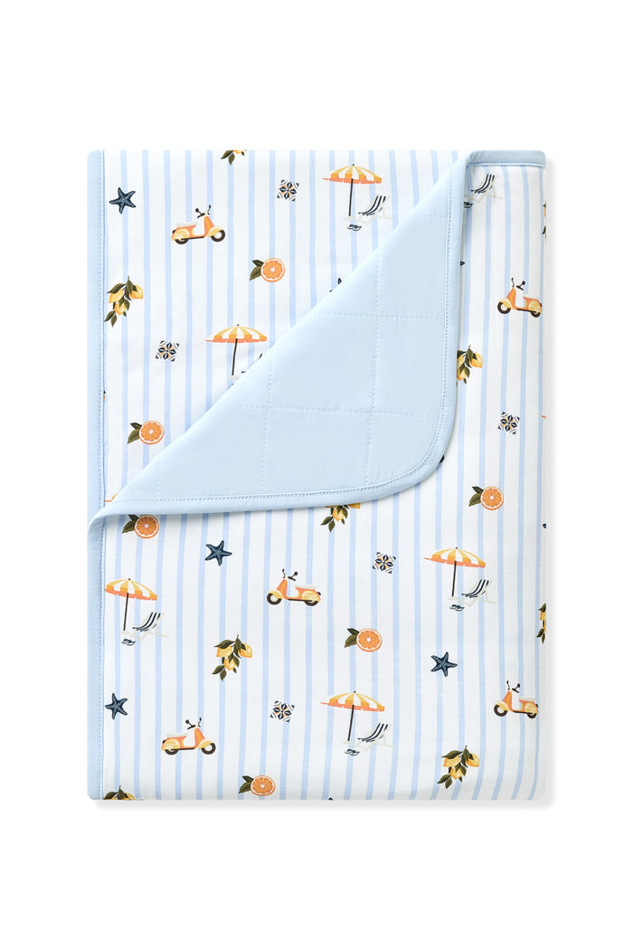 Toddler Blanket in Amalfi Coast 1.0 with the corner flipped down showing the quilted light blue backing