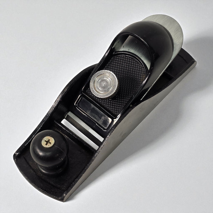 Black hand plane tool on a white background