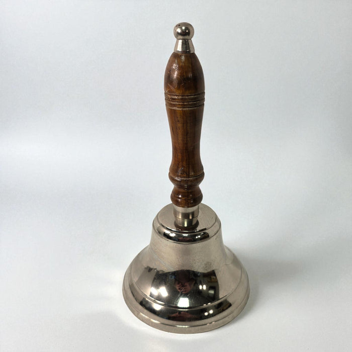 Silver bell with a wooden handle on a white background