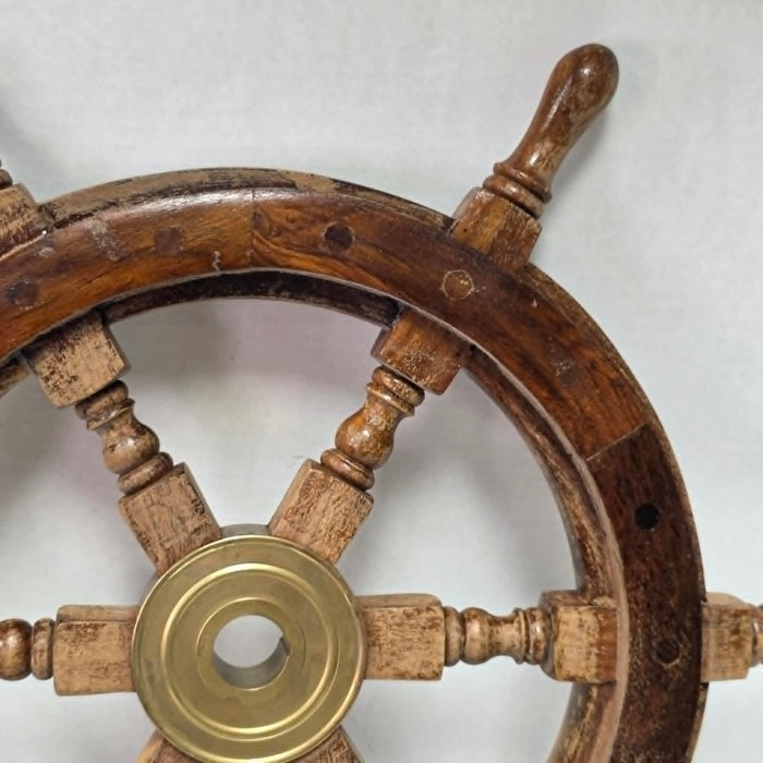 Authentic vintage wood and brass ship's wheel with beautiful original maritime patina.