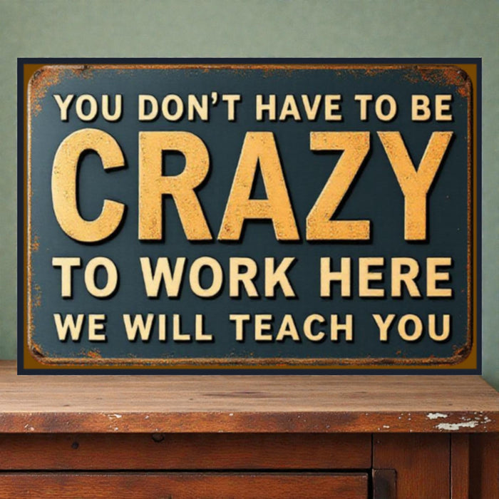 Vintage-style sign with motivational text on a wooden surface and green wall background
