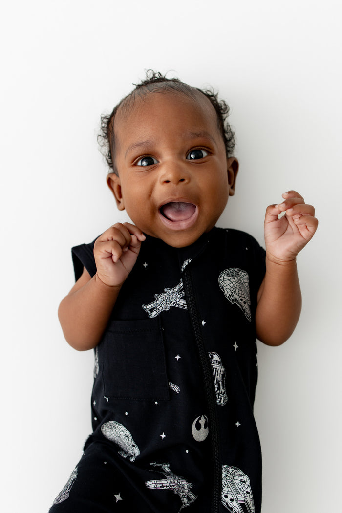 Close up of infant wearing the Zippered Sleeveless Romper in STAR WARS™